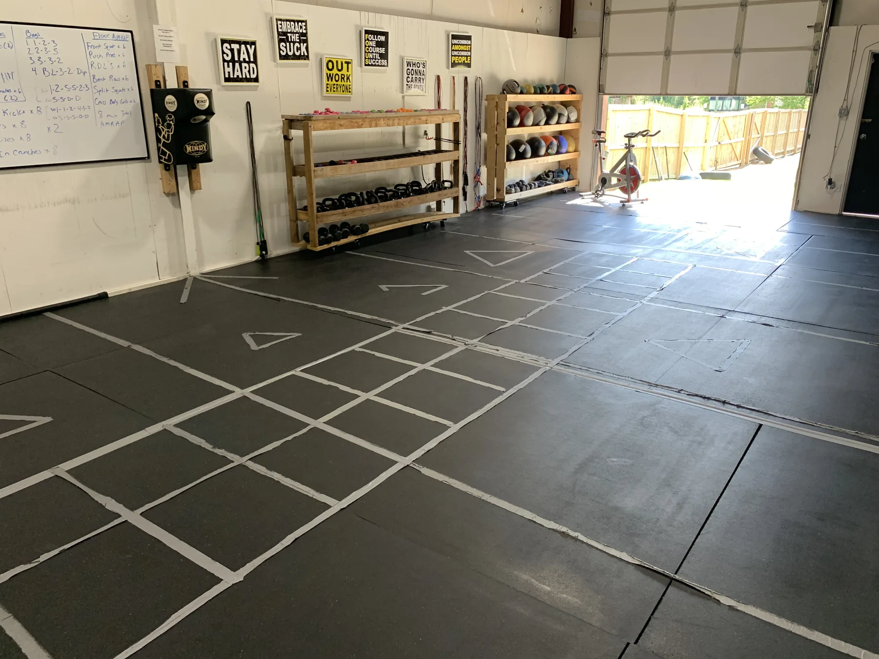 The open training floor at Major Moves Boxing & Fitness, with the equipment wall and boxing ring in view