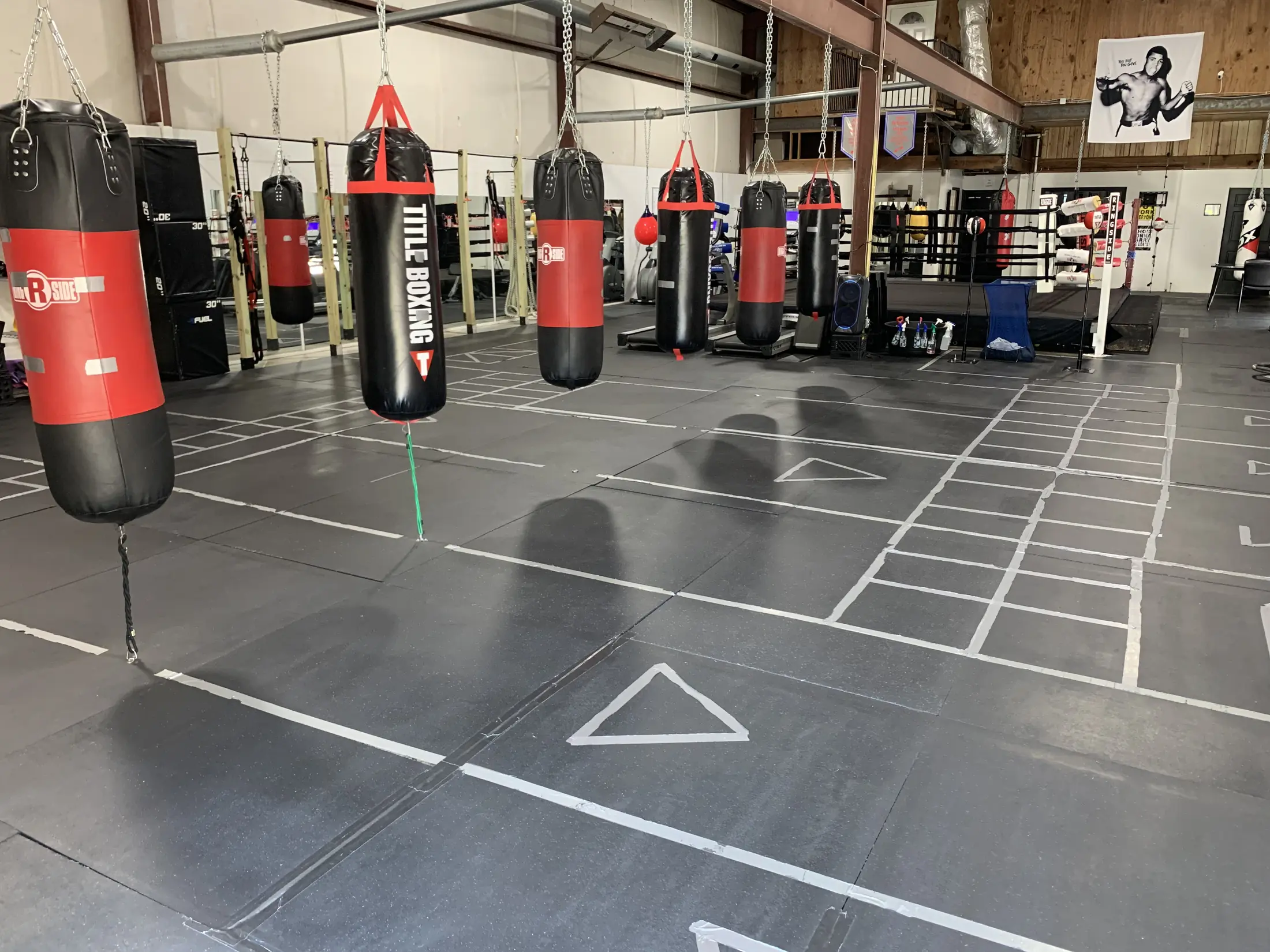 The Major Moves Boxing & Fitness training floor, lined with heavy bags and a boxing ring